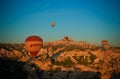 Sunrise panoramic view to Goreme city and flying balloons, Cappadocia, Turkey