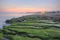 Sunrise by a peculiar rocky beach with dramatic dawning sky Royalty Free Stock Photo