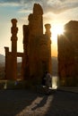 Sunrise in Persepolis, capital of the ancient Achaemenid kingdom. Ancient columns. Shadow of tourists.
