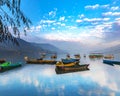 Sunrise in Phewa Lake with Multicolor boats.blue sky reflection in the lake Royalty Free Stock Photo