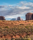 Desert landscape with buttes and mesas and cactus in foreground. Royalty Free Stock Photo