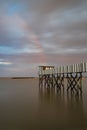 Sunrise on a pier black and white striped structure