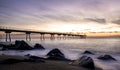 Sunrise on the Pont del petroli beach with silky water.