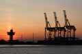 Sunrise and the port cranes Royalty Free Stock Photo