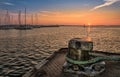 Sunrise at the port of Stralsund. A bollard in the foreground.