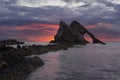 Sunrise with red clouds at bow fiddle rock near Portknockie Royalty Free Stock Photo