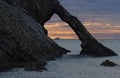 Sunrise with red clouds at bow fiddle rock near Portknockie Royalty Free Stock Photo