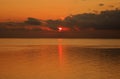 Sunrise reflected in the Ionian Sea, from behind gathering Clouds