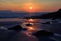 Sunrise reflected in the wet sand and rocks of Freshwater East beach