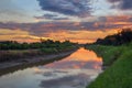Sunrise reflection in a canal Royalty Free Stock Photo