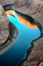 Sunrise reflection on Colorado River surface at Horseshoe Bend in Arizona