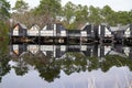 Sunrise reflection on wooden pontoon lake in Marina of Talaris in Lacanau village