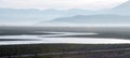 Sunrise reflections on drought stricken Lake Isabella in the southern Sierra Nevada mountains of California Royalty Free Stock Photo