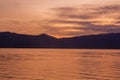 Sunrise with reflections at Lake Toba, Samosir Island, Indonesia. Royalty Free Stock Photo