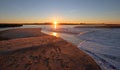 Sunrays and reeds at sunrise reflecting in the Santa Clara river / tidal inlet at McGrath State Park in Ventura California USA