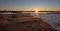 Sunrays and reeds at sunrise reflecting in the Santa Clara river / tidal inlet at McGrath State Park in Ventura California USA