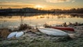 Canoes and kayaks lie on shore on a frosty fall morning at sunrise Royalty Free Stock Photo