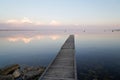 Sunrise reflexion on fishing boat wooden pontoon in sunset Lake of sanguinet france Royalty Free Stock Photo