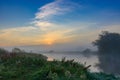 Sunrise on the river in early morning on a blue sky background. River landscape in summer morning Royalty Free Stock Photo