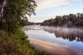 Sunrise on a river with a mist over the water Royalty Free Stock Photo
