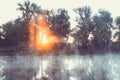 Sunrise on a river with a mist over the water Royalty Free Stock Photo