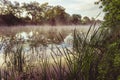 Sunrise on a river with a mist over the water Royalty Free Stock Photo