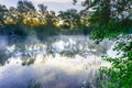 Sunrise on a river with a mist over the water Royalty Free Stock Photo