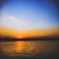 Sunrise on a river with orange and blue sky Royalty Free Stock Photo