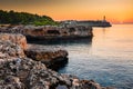 Sunrise with rocks and Porto colom lighthouse Royalty Free Stock Photo