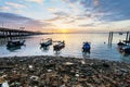 Sunrise rocky shore with fishing boat