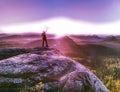 Sunrise on a rocky summit. Artist works in nature Royalty Free Stock Photo