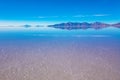 Sunrise on Salar de Uyuni in Bolivia covered with water, salt flat desert and sky reflections