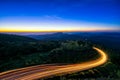 Sunrise scence of car light trail to the top with curve of road Royalty Free Stock Photo