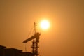 Sunrise scene housing society construction site crane machinary orange Sun and Skyline silhouette morning dawn day photography.