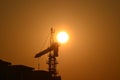 Sunrise scene housing society construction site crane machinary orange Sun and Skyline silhouette morning dawn day photography.