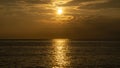 Sunrise at sea level that exudes a golden hue in summer Royalty Free Stock Photo