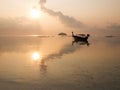 Sunrise at sea orange sky sun, long tail boat and cloud reflect with sea. Peaceful and relax feeling at tropical sea