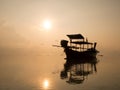 Sunrise at sea orange sky sun, long tail boat and cloud reflect with sea. Peaceful and relax feeling at tropical sea Royalty Free Stock Photo