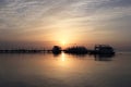 Sunrise on the sea. Pier and boats on the water. Reflection of the sun in the water. Red sea, Safaga, Egypt Royalty Free Stock Photo