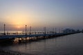 Sunrise on the sea. Pier stretching into infinity. Morning sun rays. Red sea, Safaga, Egypt Royalty Free Stock Photo