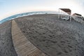 A sunrise on a sea sand beach. There are a lot of footprints on