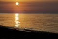 Sunrise on the sea with a seagull flies towards the camera. Morning sun above the black sea Royalty Free Stock Photo