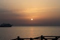 Sunrise on the sea. Wooden piles and little ship. Morning sun rays. Red sea, Safaga, Egypt Royalty Free Stock Photo