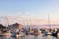 Sunrise seascape in Avalon harbor looking toward the Casino with sailboats, fishing boats and yachts moored in calm bay Royalty Free Stock Photo