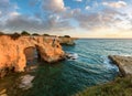 Sunrise seascape with cliffs, rocky arch and stacks faraglioni, at Torre Sant Andrea, Salento sea coast, Puglia, Italy Royalty Free Stock Photo