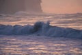 Sunrise at the seaside with big waves and clouds