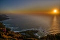 a sunrise seen from the top of a hill near the ocean on the coast of SA Royalty Free Stock Photo