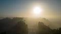 Sunrise Serenade: Mystique of Fog, Reflections and Tree Silhouettes