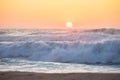 Sunrise and shining waves in ocean. Royalty Free Stock Photo