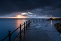 Sunrise and a lighthouse in Mevagissey harbour, Cornwall